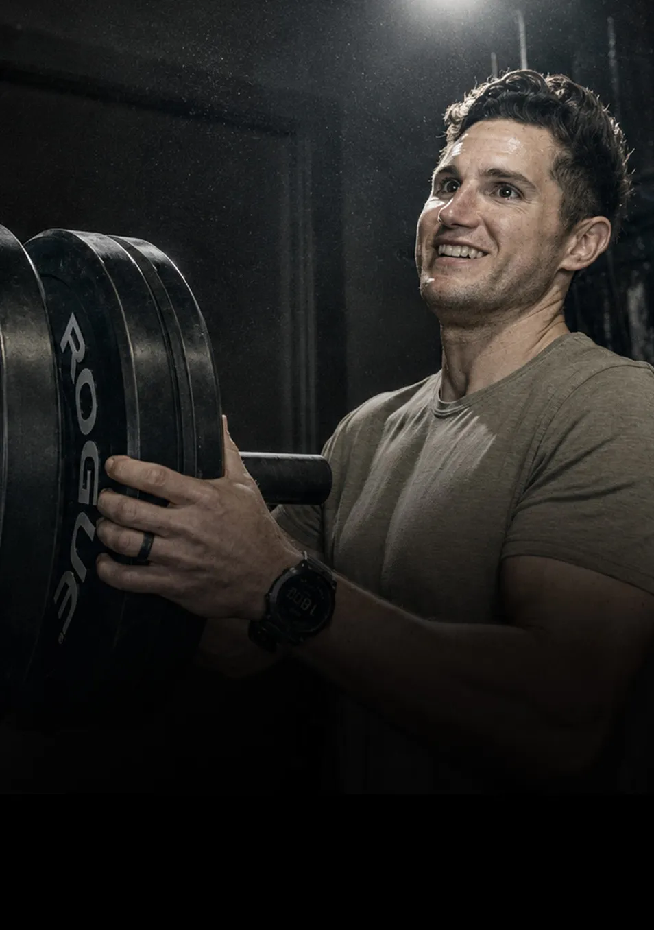 Athlete loading plates onto a barbell