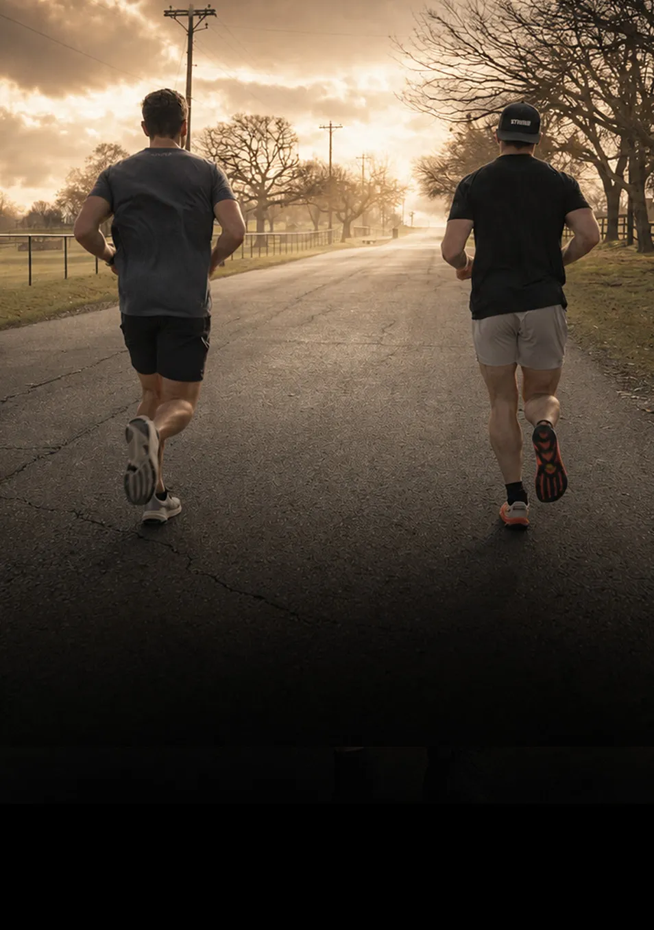 Two athletes running down a road