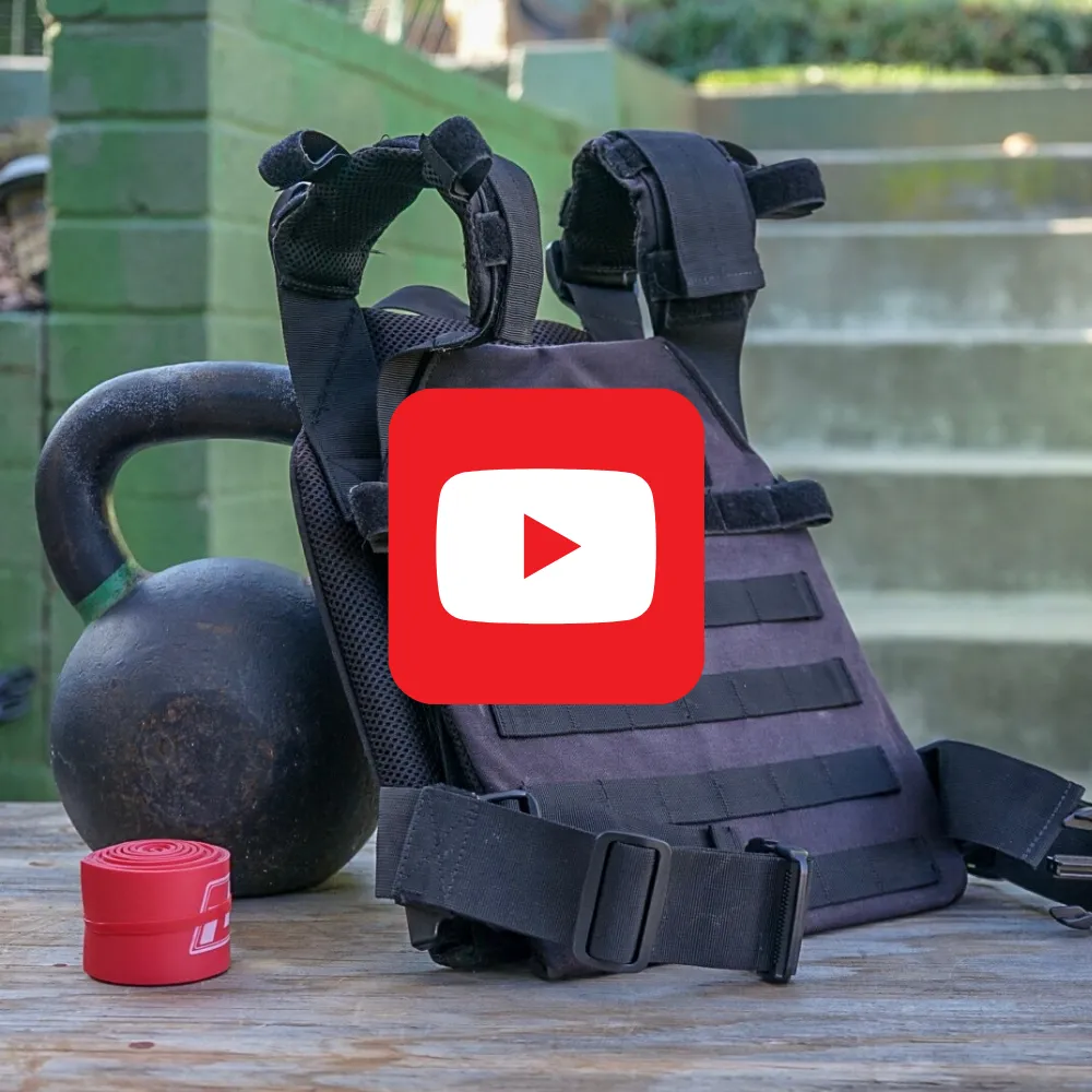 Kettlebell and weight vest in a garage gym, with a YouTube play button